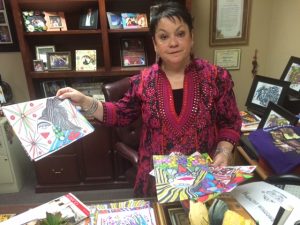 Hildy Carrillo, executive director of the Calexico Chamber of Commerce, shows some of the artwork that is such a critical part of her life.